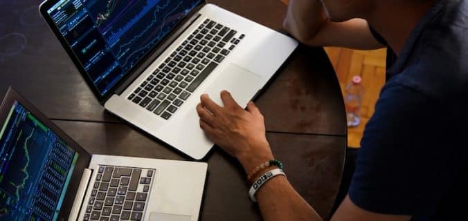 man sitting in front of the MacBook Pro
